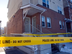 Police tape marks off the Colonial Dr. townhouse complex where Teresa Amelia Williams, 24, lived with daughter Evadne Williams-Scott. The mother is charged with the toddler's murder. (MICHAEL PEAKE/Toronto Sun)