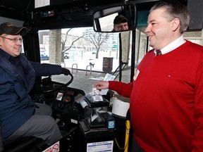 (Right to left) Edmonton City Councillor Dave Loken poses for a photo on an ETS bus with driver Kyle Rosales during the kick off for the 17th Annual Donate A Ride campaign at City Hall, last week. The Donate A Ride campaign provides transit tickets to low-income families.