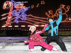Two children pose for a picture in front of the CP Holiday Train as it rolls into Wetaskiwin Dec. 10