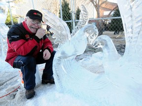 Heinz Zadler, from the Edmonton Ice Sculptors Society poses by his creation at the 2012 Deep Freeze: A Byzantine Winter Festival on Sunday. The unseasonably warm temperatures made things difficult for the artists. TREVOR ROBB/EXAMINER STAFF