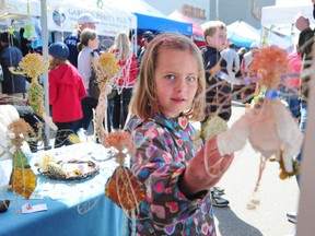 Sarah Ganley, 7, looks through one of the over 100 vendors at the opening day of the Callingwood Farmers' Market on Sunday, May 6, 2012. TREVOR ROBB/EDMONTON EXAMINER