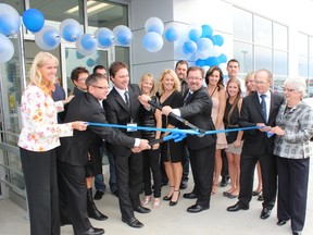 The Melody Motors family gathered to cut the ribbon on the new facility.