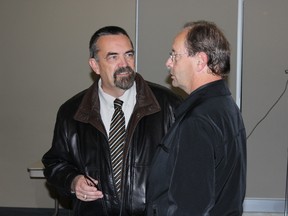 Outgoing mayor Doug Terry (left) congratulates newly elected mayor Rick Lang.
