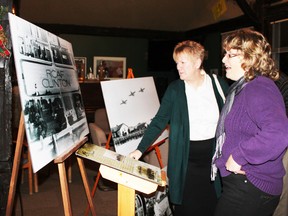 Carolyn Parks-Mintz and Tammy Martene look at an historical photo of military personnel on parade in the RCAF Clinton parade grounds as the Vanastra BR and E task force meets to discuss possible future improvements to the community.