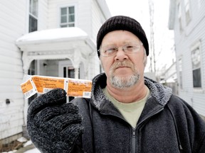 Perry Hutchins of Chatham, Ontario holds the wrapper of an insulin syringe he found in his driveway on Wednesday, January 2, 2013. The Gray Street property owner says he had to call the municipality earlier this week to clean up neighbourhood garbage that included half a dozen syringes pulled out of garbage bags by crows.  DIANA MARTIN/ THE CHATHAM DAILY NEWS/ QMI AGENCY