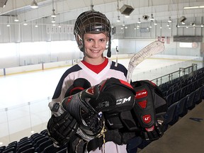 Evan Fraser holds some of his hockey equipment at the Invista Centre on Wednesday. He and Aidan Lawford-Wickham are teaming up to collect new and used hockey equipment to give to needy players so they can play hockey as well. The two boys will be at the Invista Centre from 9 a.m. to 3 p.m. on Saturday and Sunday. 
Ian MacAlpine The Whig-Standard