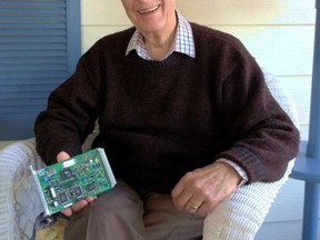 John Ross, seen here at his Florida home, holds a circuit he designed for the International Space Station.