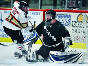 Westport Rideaus goalie Richard Barr slides across the crease as Brockville Tikis forward Alex Stephenson lurks at the goalmouth during EOJHL Rideau Division action at the Memorial Centre on Wednesday night. The Tikis lost 6-3. (STEVE PETTIBONE The Recorder and Times)