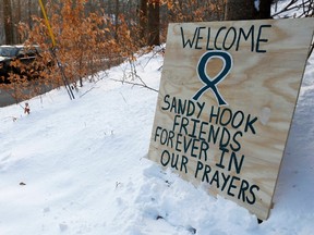 A sign is seen along the route to the Chalk Hill School where the Sandy Hook Elementary School children will attend classes in Monroe, Connecticut, January 2, 2013. The repurposed school is having an open house today and will begin hosting classes tomorrow. (REUTERS/Carlo Allegri)