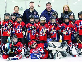 Contributed photo
Stratford Perth Auto Dismantlers novice Aces players and coaches celebrate winning the championship of the annual Mississauga Chiefs Christmas Classic girls hockey tournament last Saturday.