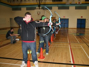 Fairview High students take careful aim at the target during the school’s archery tournament, part of a larger online contest against students at other local schools. (Chris Eakin/Fairview Post)