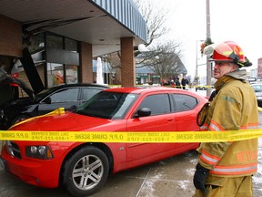 Tillsonburg firefighter Tony Hietkamp helps control the scene following a Thursday-morning motor-vehicle collision, which began on Broadway and concluded at the Town Centre Mall. The driver of a black Toyota Avalon was taken to Tillsonburg District Memorial Hospital for precautionary reasons. OPP Const. Stacey Culbert says the investigation is ongoing. Jeff Tribe/Tillsonburg News