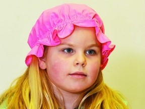 Five-year-old Anouk Degoeij of Wetaskiwin cradles her doll in her arm while she awaits the start of the craft session, which was part of the Tea for Two event held at the Wetaskiwin & District Heritage Museum Jan. 3, 2013. JEROLD LEBLANC PHOTO/WETASKIWIN TIMES/QMI AGENCY