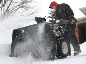Les Holmes, who works for Wayne's Property Maintenance Care, uses a snowblower to clear snow from a client's driveway and sidewalk. Local private plow operators have been busy since last week's snowstorm.
Michael Lea The Whig-Standard