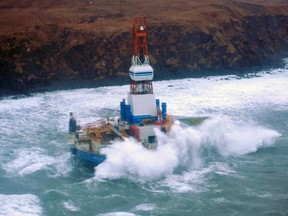 Waves crash over the conical drilling unit Kulluk where it sits aground on the southeast side of Sitkalidak Island, Alaska in this U.S. Coast Guard handout photo taken January 1, 2013.  An oil drilling rig owned by Royal Dutch Shell Plc ran aground in Alaska after drifting in stormy weather, highlighting the serious risks of working in an offshore region where some in the industry see huge potential.  (REUTERS/Petty Officer 3rd Class Jonathan Klingenberg'/USCG/Handout)