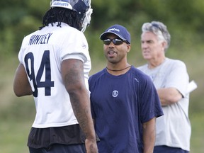 Former Argos coach Orlanado Steinauer (right) chats with DT Kevin Huntley.  (JACK BOLAND/Toronto Sun)