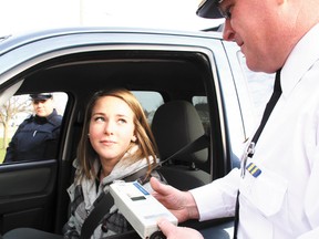 The simple message, ‘if you choose to drink, don’t drive,’ was driven home by the prosecution of the Festive RIDE Program from November 24 to January 2 in Oxford County, and a related effort in Norfolk, as illustrated by file this photo featuring Oxford OPP Inspector Tim Clark (foreground), driver Taylor Brocanier and Constable Stacey Culbert (background). Numbers of offences resulting from 2012 campaigns were roughly similar in both counties to those registered the previous year. Jeff Tribe/Tillsonburg News