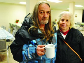 Ken Daubney and his wife, Vera, await news of their apartment's fate in a temporary shelter at The Pier Christian Church Thursday morning after an apartment building fire at the corner of Perth and Delhi streets. RONALD ZAJAC The Recorder and Times