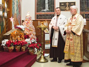 KARA WILSON, for the Expositor              

Father Stepan Didur (left) and subdeacon Paul Vandervet stand in front of a nativity scene at St. John the Baptist Ukrainian Catholic Church on Terrace Hill Street. The parish, which follows the Julian calendar, will hold Christmas liturgies on Sunday and Monday.