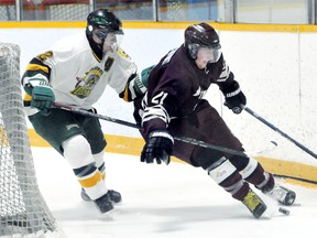 Dresden Kings' Alex Schmidt, right, is chased by Wallaceburg Lakers' Lucais Meyskens behind the Kings' net in the first period Friday in Dresden. (MARK MALONE/The Daily News)