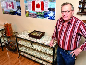 Bob Harper stands next to one of the custom cabinets made to hold the majority of his more than 8,000-piece collection of thimbles. DARCY CHEEK The Recorder and Times