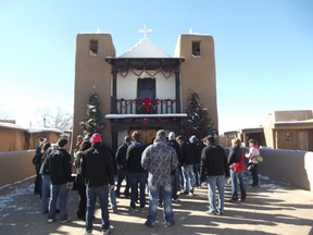St. Thomas Aquinas boys hockey team visits the Catholic Church at the Taos Pueblo World Heritage site on Friday.
TRAVIS BATTERS/For the Daily Miner and News
