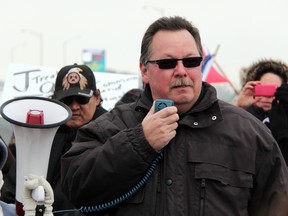 Aamjiwnaang resident Ron Plain speaks to the crowd at an Idle No More demonstration at the Blue Water Bridge in Sarnia, Ont., Saturday, Jan. 5. Plain has been ordered to pay more than $16,500 to cover legal costs for CN, as a result of Plain's part in a demonstration that closed the CN spur line in Sarnia in December. THE OBSERVER/QMI AGENCY