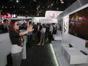 Peng Kemei of China plays a 3D game with motion-sensing technology in this file photo from the International Consumer Electronics Show (CES) in Las Vegas, Nevada, January 10, 2012. (REUTERS/Steve Marcus)