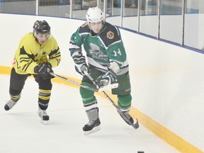 Welland Whalers forward Chris Downey, right, is shadowed by Whitby Dunlops defender Chris Johnston in Allan Cup Hockey senior A action Saturday night at Welland Arena. JOE CSEH Tribune Photo