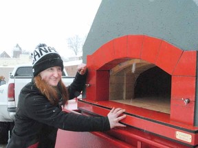 Emma House, a second year student at Stratford Chefs School, helped Sunday with the setup of this mobile, wood-fired oven installed outside The Old Prune restaurant.