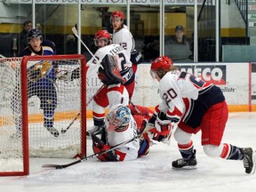 Oil Barons forward Parker Evans-Campbell watches as Brooks Bandits Dylan Bredahl clears the puck from the Bandits’ goalline during the MOB’s 5-1 loss to the Bandits. TREVOR HOWLETT/TODAY STAFF