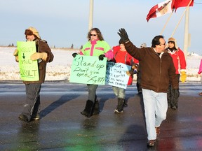 Mattagami First Nation Elder Morris Naveau, right, helps direct traffic at an Idle No More protest in Timmins on Saturday. As an elder in his community, Naveau said his role was to keep the peace and ensure that the protest went smoothly and helped inform people rather than turn them off.