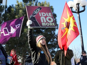 High school student Maddy Ross, 16, participates in an Idle No More demonstration at the intersection of Princess and Barrie streets Saturday. Demonstrators handed out information to passing motorists and pedestrians during the event. (Danielle VandenBrink The Whig-Standard)