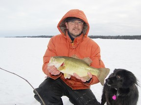 Sudbury Star sports editor Bruce Heidman shows off a large-mouth bass he just caught on Lake Nipissing on Saturday, January 5, 2013. Jonathan Migneault/The Sudbury Star/QMI Agency