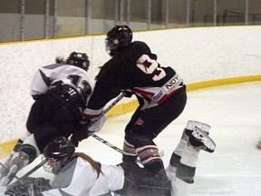 Sherwood Park Steele leading scorer Maria Houle (bottom) crashes head-first into the boards and suffered an injury in her team’s 2-1 loss to Fort Saskatchewan on Friday at the Shell. Photo by Shane Jones/Sherwood Park News/QMI Agency