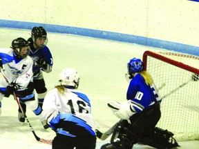 Katie Marcine and Jenna Andrews attempt to get the puck past the Fargo Freeze goalie in the semi final.