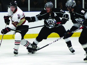 Tanner Benton of the Brockville Tikis looks for an open teammate while under pressure from Vance Thompson (17) and Alex Conroy-Terrance of the Akwesasne Wolves during their game on Saturday in Gananoque as part of the Rideau-St. Lawrence Showcase. Brockville lost 4-3 in a shootout. (AMANDA SMITH Qmi Agency)