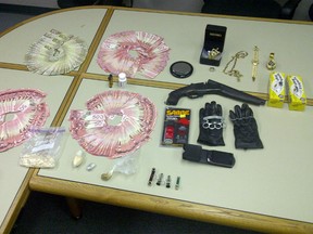 Police seized a sawed-off shotgun, brass knuckles, pepper spray, $20,000 in Canadian currency, 125.4 grams of cocaine, 16.9 grams of heroin, plus a quantity of pills and hash oil in a drug bust Sunday in Kingston.