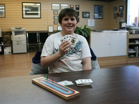 Ryan Bell with his winning cribbage hand of four fives and Jack of spades.