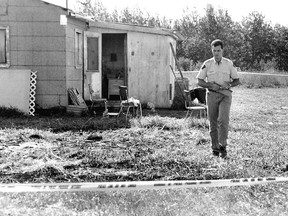 August 10, 1991: RCMP Constable Tom Caverly walks behind police lines at a hobby farm where four family members were killed on Aug. 6, 1991. The then 15-year-old gunman Gavin Joseph Mandin killed four members of his St. Albert family on a hobby farm near Valleyview. Killed were Madin’s stepfather Maurice, mother Susan and sisters Islay, 10, and Janelle, 12. (File Photo/QMI Agency)