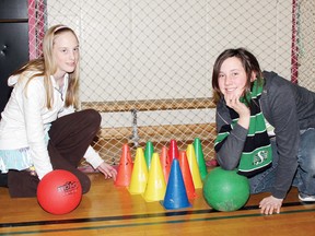 Alicia Wiseman (left) and Abby Schonnop, members of the Boys and Girls Club of Pembroke's Torch Club, set up a bowling game for the members during recreation night at Fellowes High School. For more community photos, please visit our website photo gallery at www.thedailyobserver.ca.