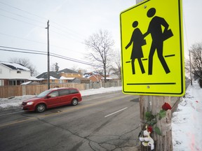 A rose and stuffed bear were taped to a pole at the intersection of Murphy Road and Cathcart Boulevard Tuesday, where a 10-year-old girl was struck by a vehicle one day earlier. Jillian Keck later died in hospital. (TYLER KULA, The Observer)