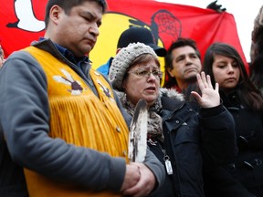 Attawapiskat Chief Theresa Spence, centre, speaks during a news conference outside her teepee on Victoria Island in Ottawa January 4, 2013. (REUTERS/Chris Wattie)