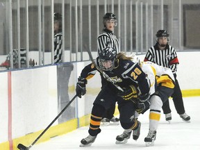 TERRY FARRELL/DAILY HERALD-TRIBUNE
Slash forward Deanna Morin has to grab onto Corbin Welsh as the Storm forward gets past. The Grande Prairie Storm beat the St. Albert Slash 3-2 in Alberta Major Midget Female Hockey League action at the Coca-Cola Centre, Saturday.