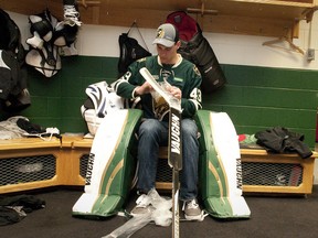 The newest London Knight, goaltender Anthony Stolarz, unwraps his new sticks, surrounded by new goalie equipment, at Budweiser Gardens on Tuesday.  (CRAIG GLOVER, The London Free Press)