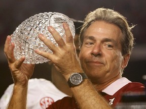 Alabama head coach Nick Saban hoists The Coaches Trophy after the Crimson Tide dismantled the Notre Dame Fighting Irish Monday night to win BCS national championship in Miami. It is the fourth national title for Saban and his third with Alabama. (Reuters)