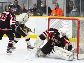 Trenton Golden Hawks' Jordan Minello watches as Stouffville Spirit goalie Daniel Mannella bobbles a shot that just crosses the goal line during the Hawks' 4-1 win Saturday at the Community Gardens. The Hawks also edged the Aurora Tigers 4-3 in a shootout Friday, and crushed the Pickering Panthers 12-1 Sunday to run their home-ice win streak to 11 games and move them into first place overall in the OJHL.