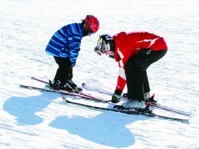 Ski instructor Mackenzie Gamble (right) works with Cooper Cowan Saturday during the first day of ski lessons at Laurentian Valley’s Alice Hill Park. About 170 people are signed up for lessons this year.