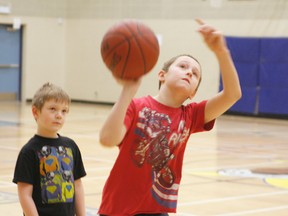 Erin Steele/R-G
Adam Peters takes a shot as Lindon Potts looks on during a drill at the Basketball and Healthy Life Skills Camp held last week at Peace River High School.