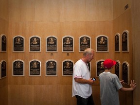 Greg Justice and his son Ben of Springboro, Ohio, tour the National Baseball Hall of Fame in Cooperstown, New York, July 22, 2012. Former Cincinnati Reds shortstop Barry Larkin and Chicago Cubs third baseman Ron Santo are scheduled to be inducted later today. (REUTERS/Adam Fenster)